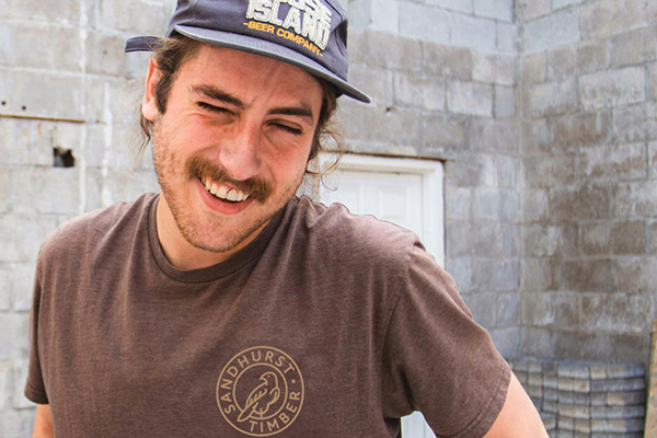 Sandhurst Timber founder in a branded cap and shirt